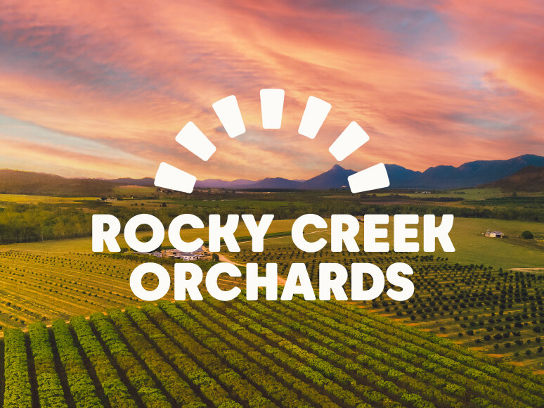 Rocky Creek Orchards Brandmark on photograph of sunset over orchards